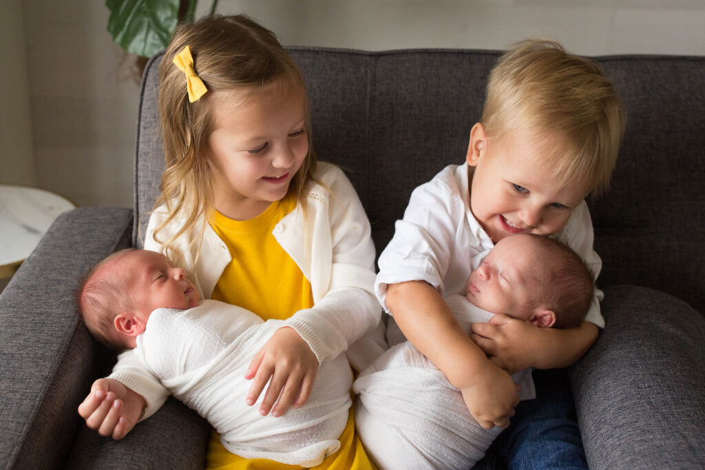 newborn photographer in oklahoma city photographing new family of 4 in studio