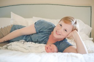 mom snuggling newborn baby