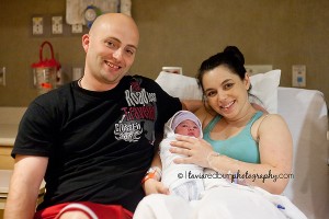 mom and dad with newborn girl