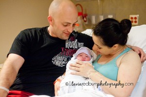 mom and dad with baby newborn girl