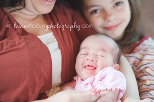 newborn baby girl smiling with her mom in yukon oklahoma