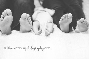 newborn feet with mom and dad's feet on bed oklahoma photographer newborn okc