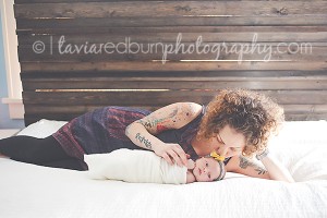 oklahoma lifestyle photography newborn mom on bed kissing baby girl