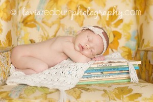 newborn baby girl laying on old books oklahoma