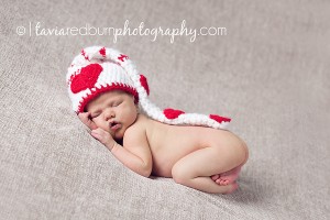 posed newborn baby girl with valentine's day hat