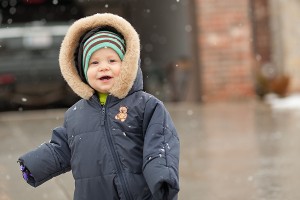 toddler laughing in snow