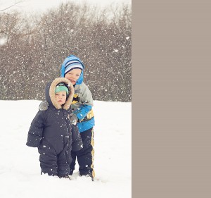 siblings playing in snow