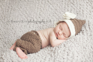 sleeping newborn girl with bonnet and crochet pants
