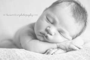 black and white image of sleeping newborn baby girl