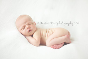 boy newborn posed on white blanket, tush in air pose