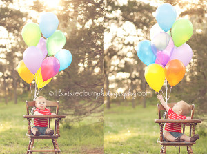 1 year old toddler in a wood high chair with balloons