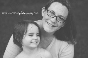 black and white image of mom and daughter laughing