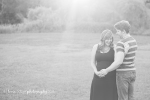 couple laughing, maternity photo, black and white, backlit
