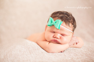 newborn baby girl with turqouise bow