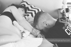 dad praying with mom while she labors at home