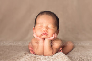 cute newborn head in hands pose