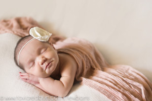 posed newborn baby girl smiling