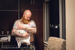 tattoo dad snuggling baby after birth