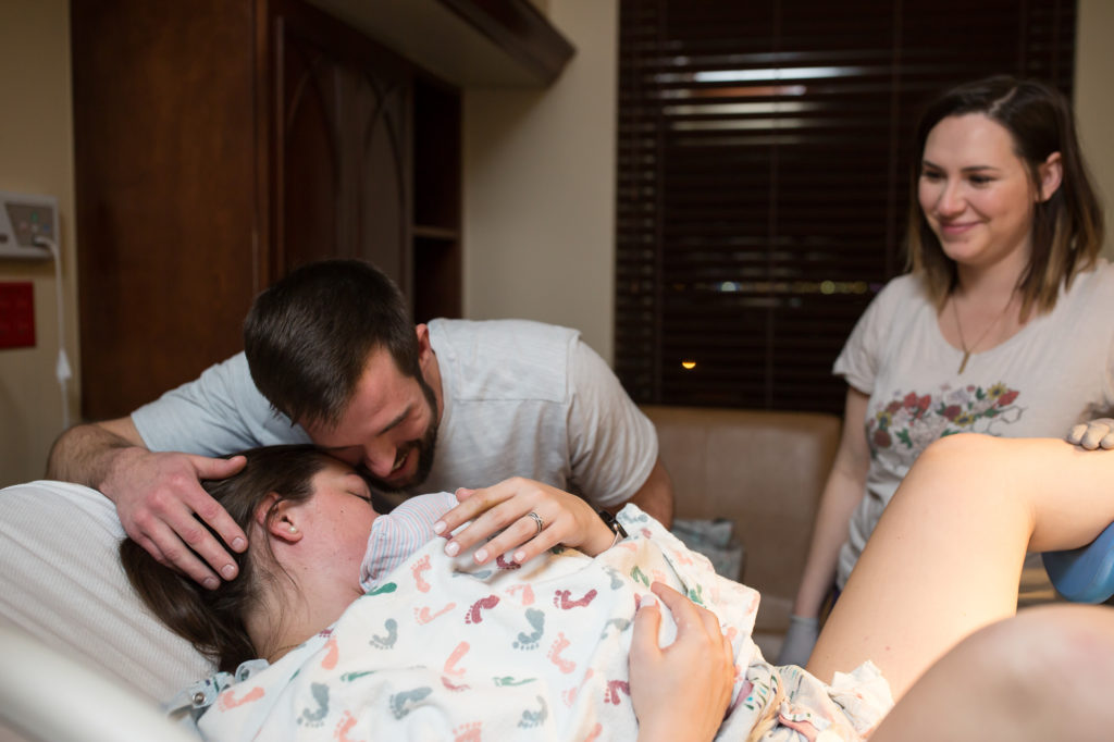 Doula watching couple snuggle their new baby birth photography oklahoma city