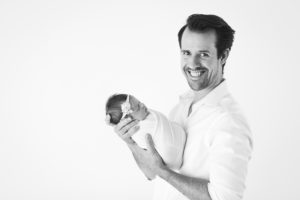dad smiling holding his first baby newborn oklahoma photography